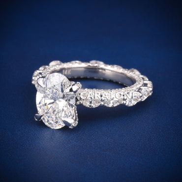 Oval cut diamond engagement ring in white gold with full halo and side stones