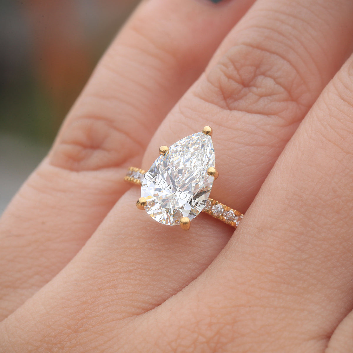 Exclusive Premium Pear Cut Solitaire Ring With Brilliant White Center Stone, Sparkling Pave Set Side Stones, Elegant Yellow Gold Tone Band And Unique Luxury Designer Engagement Jewelry For Women