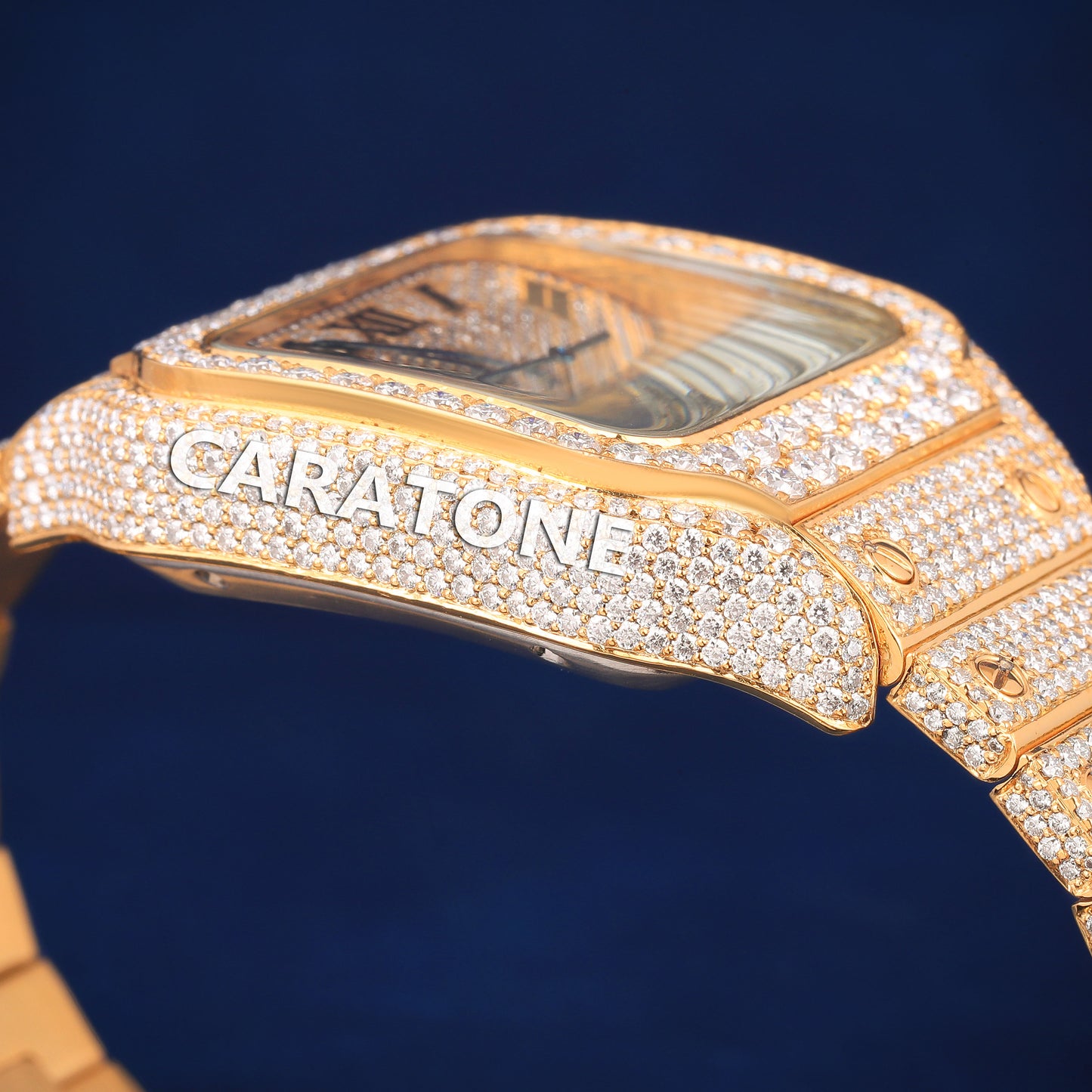 Hip hop full iced out branded watch in gold tone with black roman numerals in it