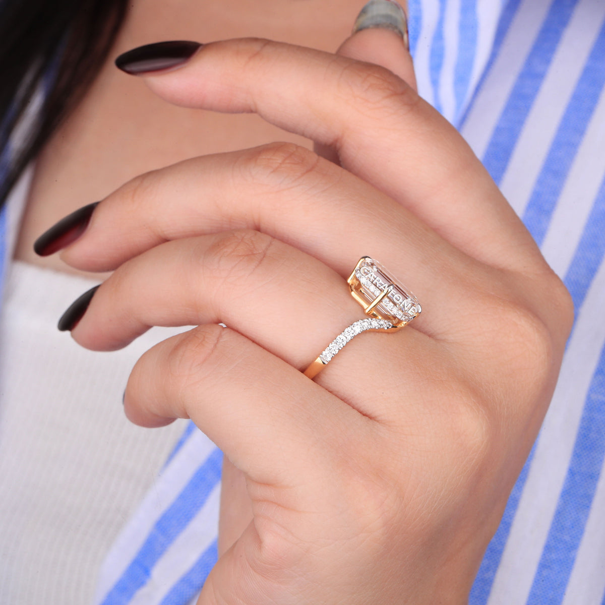 Elegant Yellow Gold Diamond Engagement Ring with a Stunning Emerald-Cut Center Stone and Brilliant Diamond-Studded Band