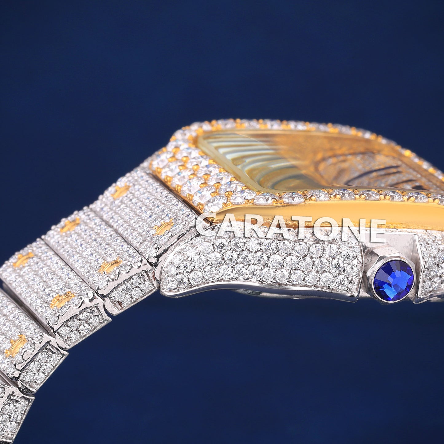 Full iced out hip hop branded watch in two tone with black arabic numerals in dial and it is of D VVS clarity
