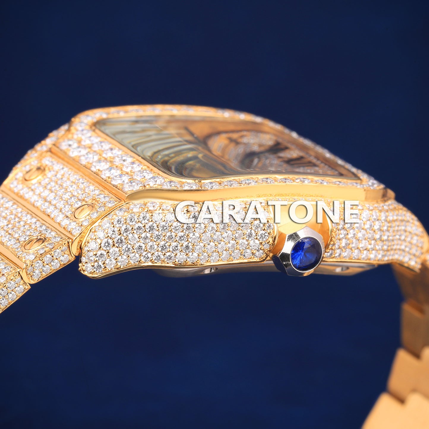 Hip hop full iced out branded watch in gold tone with black roman numerals in it
